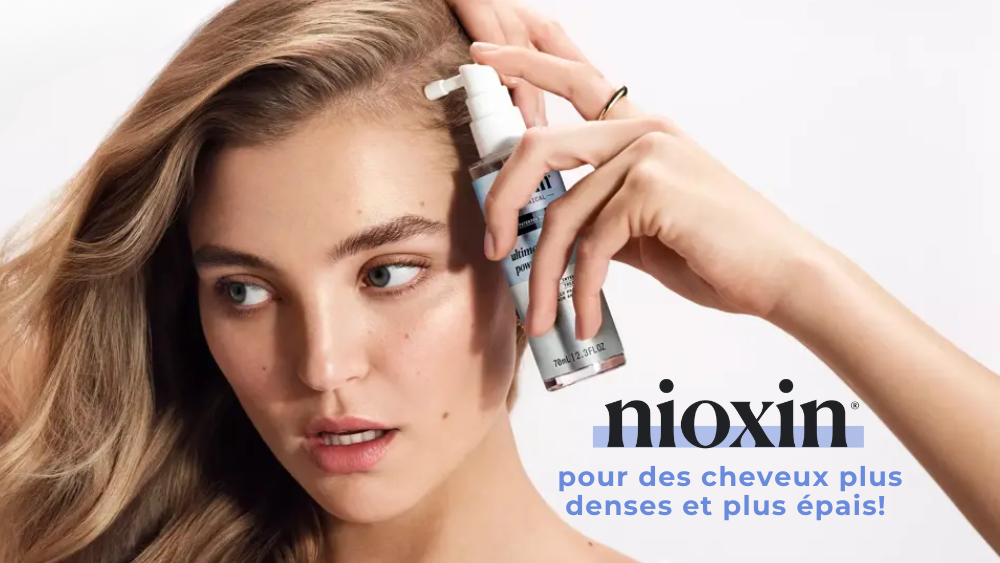 Nioxin propose un sérum pour des cheveux plus denses et plus épais, appliqué par une jeune femme aux cheveux longs.